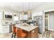 Modern kitchen with white cabinets, a granite island with seating, and stainless steel appliances at 6301 Prospect St, Indianapolis, IN 46203
