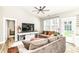 Bright living room with vaulted ceiling, ceiling fan, and comfortable sofa at 6301 Prospect St, Indianapolis, IN 46203