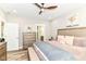 Main bedroom featuring wood flooring, a ceiling fan, and ensuite access at 6301 Prospect St, Indianapolis, IN 46203