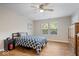 Comfortable bedroom with a ceiling fan, window, and hardwood floors; perfect for relaxation at 6333 Pinebark Pl, Indianapolis, IN 46217