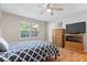 Inviting bedroom with a ceiling fan, window, and wood floors for a cozy and restful retreat at 6333 Pinebark Pl, Indianapolis, IN 46217