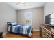 This bedroom features a bed, dresser, window and wood floors at 6333 Pinebark Pl, Indianapolis, IN 46217