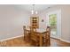 Cozy dining area featuring hardwood floors, a wooden table with chairs, and natural light at 6333 Pinebark Pl, Indianapolis, IN 46217