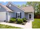 Exterior front view with blue siding, well-kept bushes, and a sidewalk leading to the front door at 6333 Pinebark Pl, Indianapolis, IN 46217