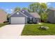 Charming single-story home featuring a two-car garage, manicured lawn, and inviting curb appeal at 6333 Pinebark Pl, Indianapolis, IN 46217