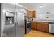 Well-equipped kitchen featuring stainless steel appliances, wood cabinets, and sleek countertops at 6333 Pinebark Pl, Indianapolis, IN 46217