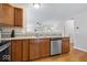 Kitchen featuring stainless steel appliances, wooden cabinets, and a breakfast bar overlooking the living area at 6333 Pinebark Pl, Indianapolis, IN 46217