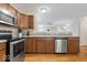 This kitchen features stainless steel appliances and a serving counter with a view into another room at 6333 Pinebark Pl, Indianapolis, IN 46217