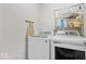 Bright laundry room features modern washer and dryer, plus ample storage and shelving at 6333 Pinebark Pl, Indianapolis, IN 46217