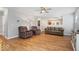 Inviting living room featuring hardwood floors, cozy seating, and a view into the dining area at 6333 Pinebark Pl, Indianapolis, IN 46217