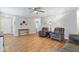 Open living space with hardwood floors, comfortable armchairs, and neutral wall colors at 6333 Pinebark Pl, Indianapolis, IN 46217
