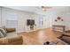 Spacious living room with hardwood floors, a ceiling fan, and comfortable seating at 6333 Pinebark Pl, Indianapolis, IN 46217