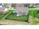 Aerial perspective of a home with fenced backyard, mature trees, and inviting outdoor living spaces at 6784 W May Apple Dr, McCordsville, IN 46055