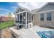 Screened-in porch and patio with grill and outdoor kitchen overlooking the backyard at 6784 W May Apple Dr, McCordsville, IN 46055