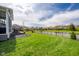Spacious backyard overlooking a serene pond, featuring a well-kept lawn and partial fence, ideal for relaxation at 6784 W May Apple Dr, McCordsville, IN 46055
