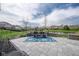 Inviting stone patio with a dining table and view of pond and neighborhood at 6784 W May Apple Dr, McCordsville, IN 46055