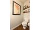 A cozy bathroom features a toilet and decorative art on the walls at 6784 W May Apple Dr, McCordsville, IN 46055