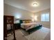 A beautifully staged bedroom features a decorative bed frame and plush pillows at 6784 W May Apple Dr, McCordsville, IN 46055
