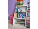 A well-stocked bookshelf filled with a variety of books and toys at 6784 W May Apple Dr, McCordsville, IN 46055