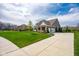Charming home with manicured front lawn, long driveway, mature trees, and inviting curb appeal at 6784 W May Apple Dr, McCordsville, IN 46055
