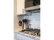 Stainless steel gas cooktop with white subway tile backsplash and black hardware at 6784 W May Apple Dr, McCordsville, IN 46055