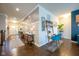 Hallway featuring paneled walls, wood floors, and natural light connecting different areas of the home at 6784 W May Apple Dr, McCordsville, IN 46055