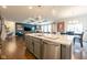 Open-concept kitchen with island, granite countertops, stainless steel appliances, and seamless flow to the living area at 6784 W May Apple Dr, McCordsville, IN 46055