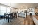 Spacious kitchen with a central island, modern appliances, and an adjacent dining area, ideal for Gathering gatherings at 6784 W May Apple Dr, McCordsville, IN 46055