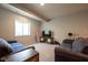 Inviting living room with comfortable blue couches, a media center, and natural light from the window at 6784 W May Apple Dr, McCordsville, IN 46055