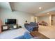 Spacious living room with plush blue sofas, carpeted floors, and a media center at 6784 W May Apple Dr, McCordsville, IN 46055