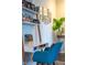 Bright home office featuring a stylish desk with open shelving, gallery wall, and comfortable chair at 6784 W May Apple Dr, McCordsville, IN 46055