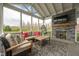 Relaxing screened-in porch with stone fireplace and comfortable seating at 6784 W May Apple Dr, McCordsville, IN 46055