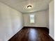 A bright bedroom features hardwood floors, white walls, and a window offering natural light at 692 S Crawford St, Martinsville, IN 46151