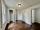 Bedroom featuring hardwood floors, neutral walls, with an open closet door and connecting bathroom at 692 S Crawford St, Martinsville, IN 46151