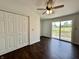 Cozy bedroom with wood floors, closet, and a sliding glass door to the backyard at 692 S Crawford St, Martinsville, IN 46151