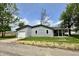 Charming gray home featuring a front-facing garage and lush green lawn and yard at 692 S Crawford St, Martinsville, IN 46151
