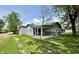 Charming gray home featuring a covered front porch, lush green lawn, and a sidewalk at 692 S Crawford St, Martinsville, IN 46151