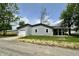A home with gray siding, garage, covered front porch, and a grassy front yard at 692 S Crawford St, Martinsville, IN 46151