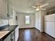 Bright kitchen featuring a ceiling fan, white appliances, and hardwood floors at 692 S Crawford St, Martinsville, IN 46151