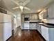 Spacious kitchen with gray cabinets, white appliances, and hardwood floors at 692 S Crawford St, Martinsville, IN 46151