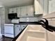 Modern kitchen features white cabinets, black hardware, stainless steel appliances, and white tile backsplash at 692 S Crawford St, Martinsville, IN 46151
