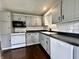 Bright kitchen featuring white appliances and gray cabinets at 692 S Crawford St, Martinsville, IN 46151