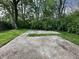 Backyard with a concrete pad surrounded by green grass and trees at 741 Springmill Dr, Mooresville, IN 46158
