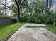 Backyard featuring a grassy area and a concrete pad surrounded by many trees at 741 Springmill Dr, Mooresville, IN 46158