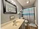 Cozy bathroom with a decorative mirror, a shower with a beach-themed curtain, and a bright vanity at 741 Springmill Dr, Mooresville, IN 46158