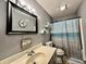 Cozy bathroom with a decorative mirror, a shower with a beach-themed curtain, and a bright vanity at 741 Springmill Dr, Mooresville, IN 46158