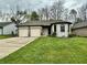 Charming single-Gathering home featuring manicured front lawn and three-car garage at 741 Springmill Dr, Mooresville, IN 46158