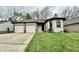 Charming single-story home with a two-car garage and well-manicured lawn at 741 Springmill Dr, Mooresville, IN 46158