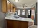 Features wood cabinets, stylish backsplash, a double sink, white countertops, and natural light at 741 Springmill Dr, Mooresville, IN 46158