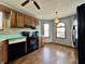 Classic kitchen featuring wood cabinets, black appliances, decorative backsplash, and natural light at 741 Springmill Dr, Mooresville, IN 46158